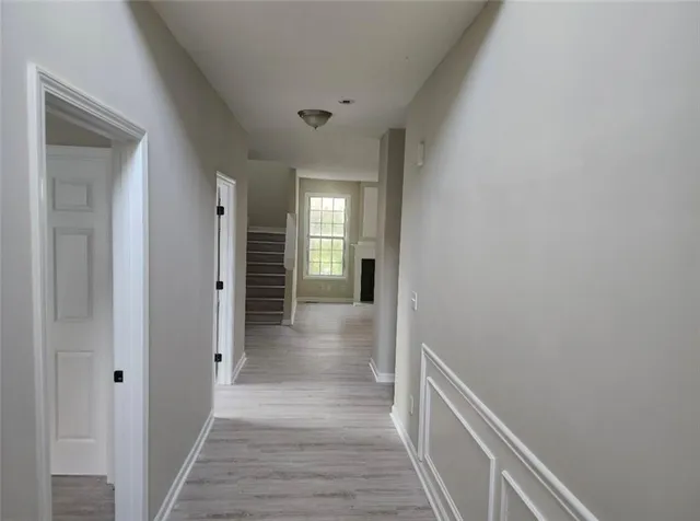 a view of a hallway with wooden floor