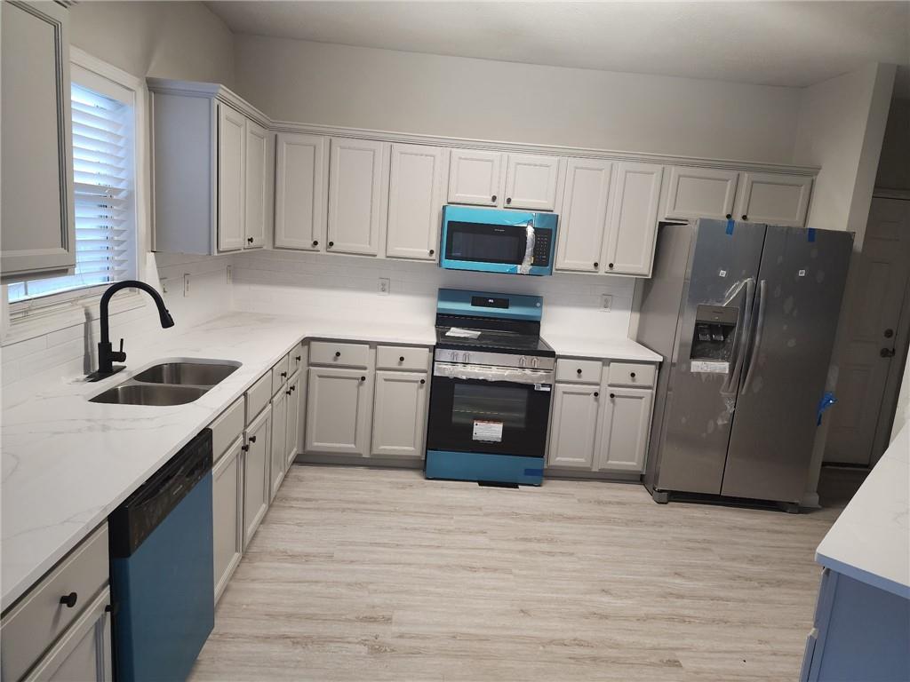 138 Shady View Place Lawrenceville, GA 30044 - Photo 5 of 21 a kitchen with stainless steel appliances granite countertop a sink stove and refrigerator