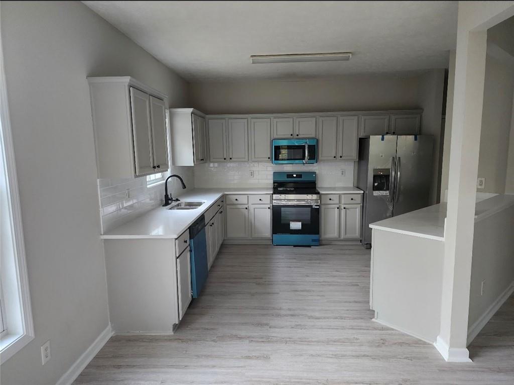 138 Shady View Place Lawrenceville, GA 30044 - Photo 7 of 21 a kitchen with stainless steel appliances granite countertop a sink stove refrigerator and cabinets