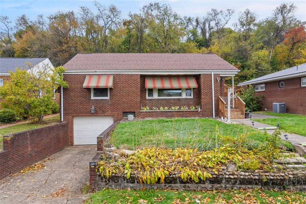 1233 Virginia Avenue Midland, PA 15059 - Photo 1 of 44 a front view of a house with garden