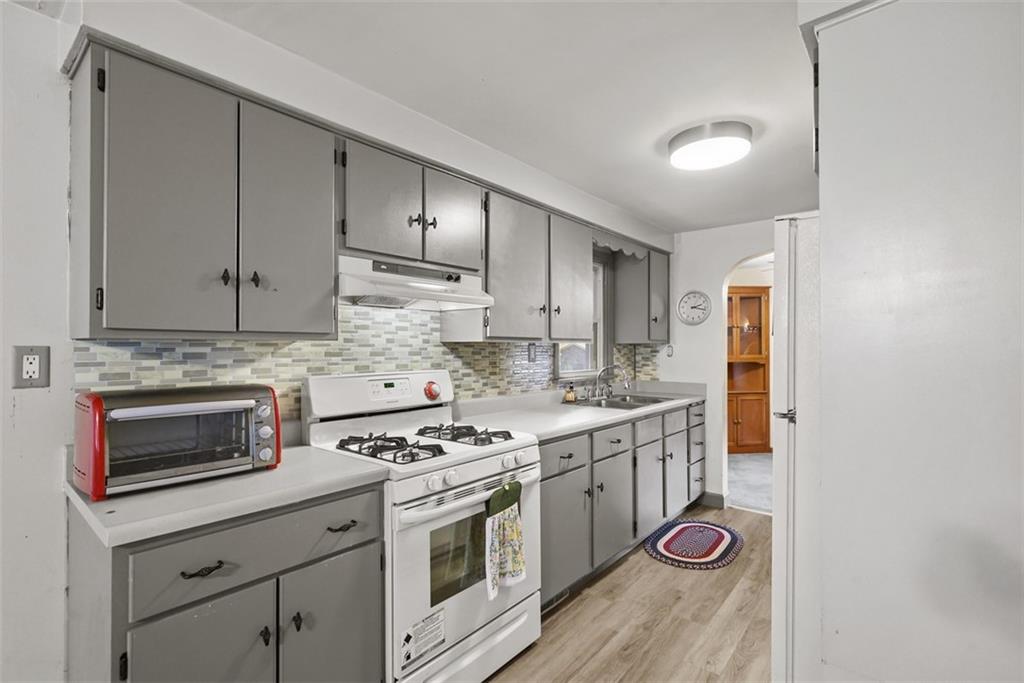 1233 Virginia Avenue Midland, PA 15059 - Photo 14 of 44 a kitchen with a stove and a microwave