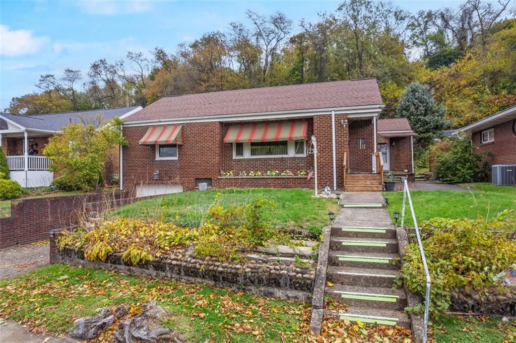 1233 Virginia Avenue Midland, PA 15059 - Photo 2 of 44 a front view of a house with a garden
