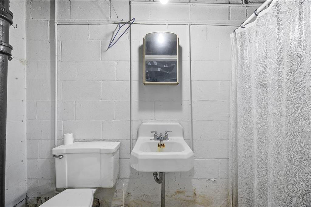 1233 Virginia Avenue Midland, PA 15059 - Photo 33 of 44 a bathroom with a sink a toilet and shower