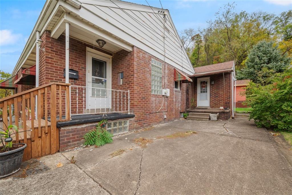 1233 Virginia Avenue Midland, PA 15059 - Photo 5 of 44 a backyard of a house with barbeque oven and outdoor seating