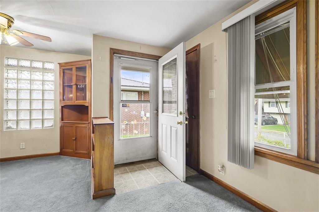 1233 Virginia Avenue Midland, PA 15059 - Photo 6 of 44 an empty room with windows closet and fireplace