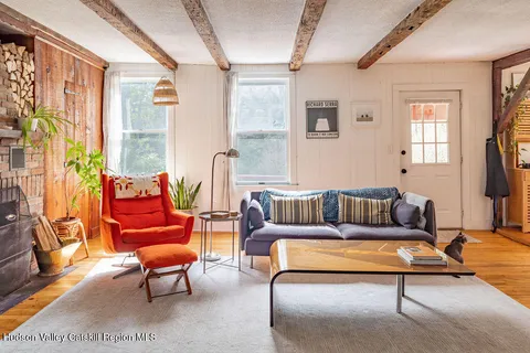 a living room with furniture a rug and a large window