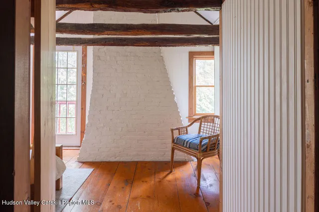 a view of a livingroom with furniture and a window