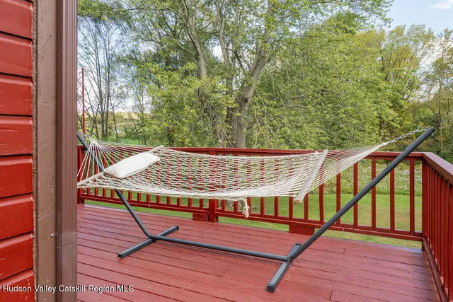 a view of balcony with wooden floor and fence
