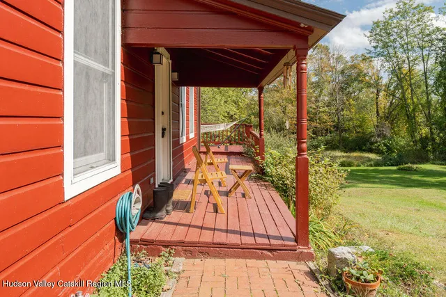 a view of a balcony with yard