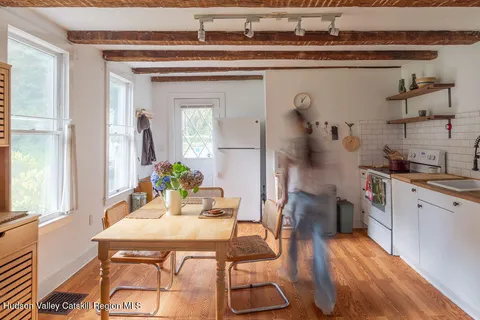a dining room with furniture and wooden floor