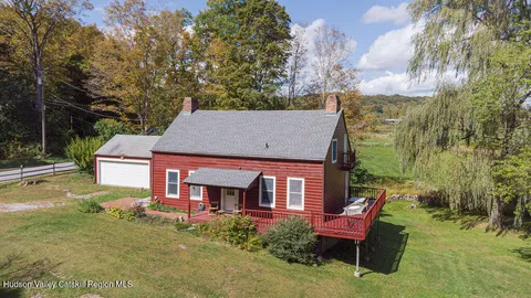 aerial view of a house with a yard table and chairs