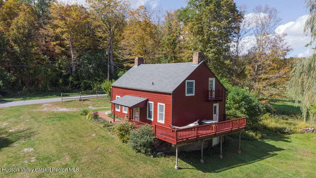 a backyard of a house with yard and outdoor seating