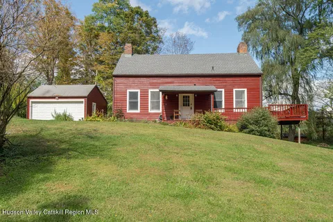 a view of a house with a yard from a lake