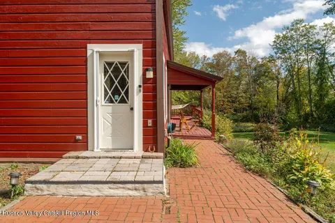 a view of a pathway of a house with potted plants
