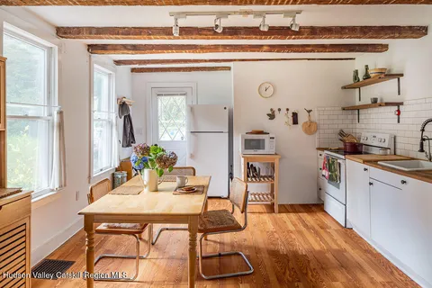 a dining hall with a sink and breakfast area