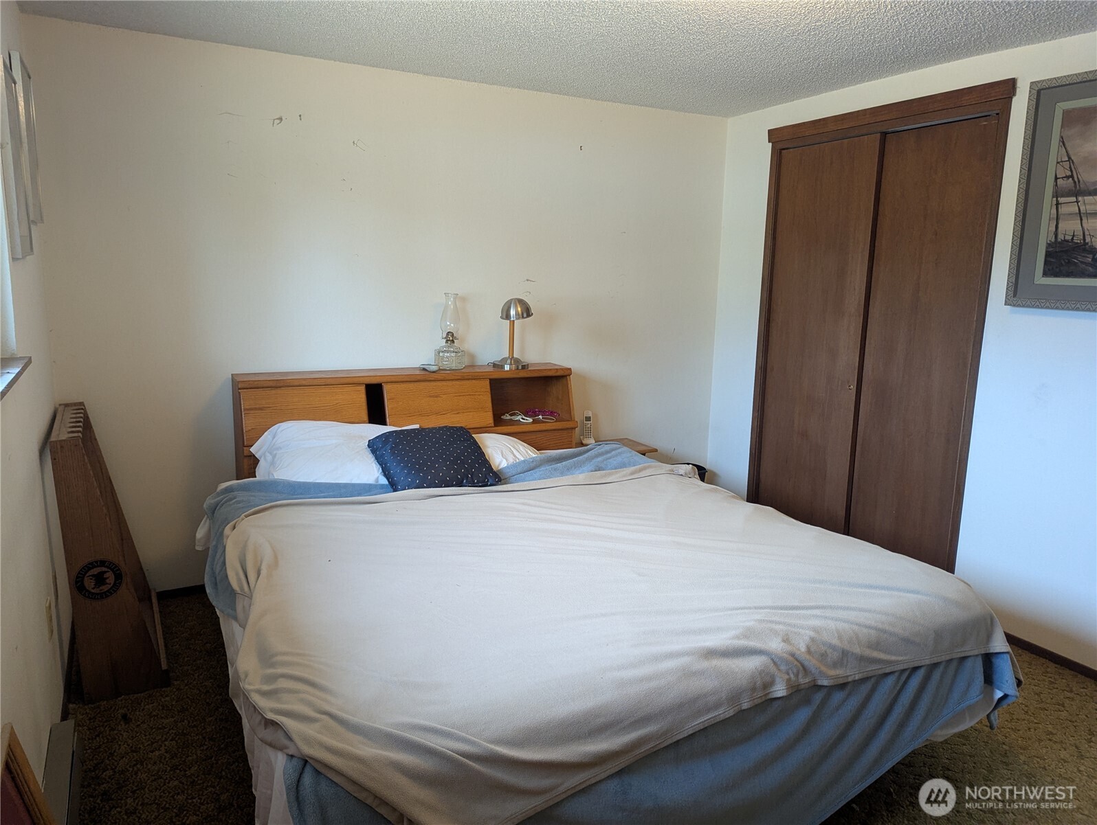 72 Ridge View Drive Sequim, WA 98382 - Photo 8 of 31 a bedroom with a bed and wooden floor