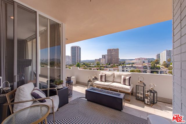 a balcony with furniture and a view of balcony