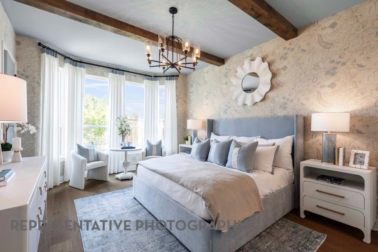 21235 Natalia Grove Magnolia, TX 77355 - Photo 12 of 34 a bedroom with a large bed and a chandelier