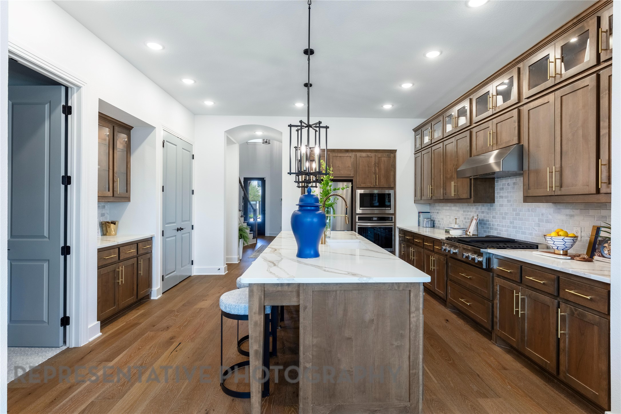21235 Natalia Grove Magnolia, TX 77355 - Photo 5 of 34 a kitchen with stainless steel appliances kitchen island granite countertop a refrigerator a stove top oven a sink and dishwasher