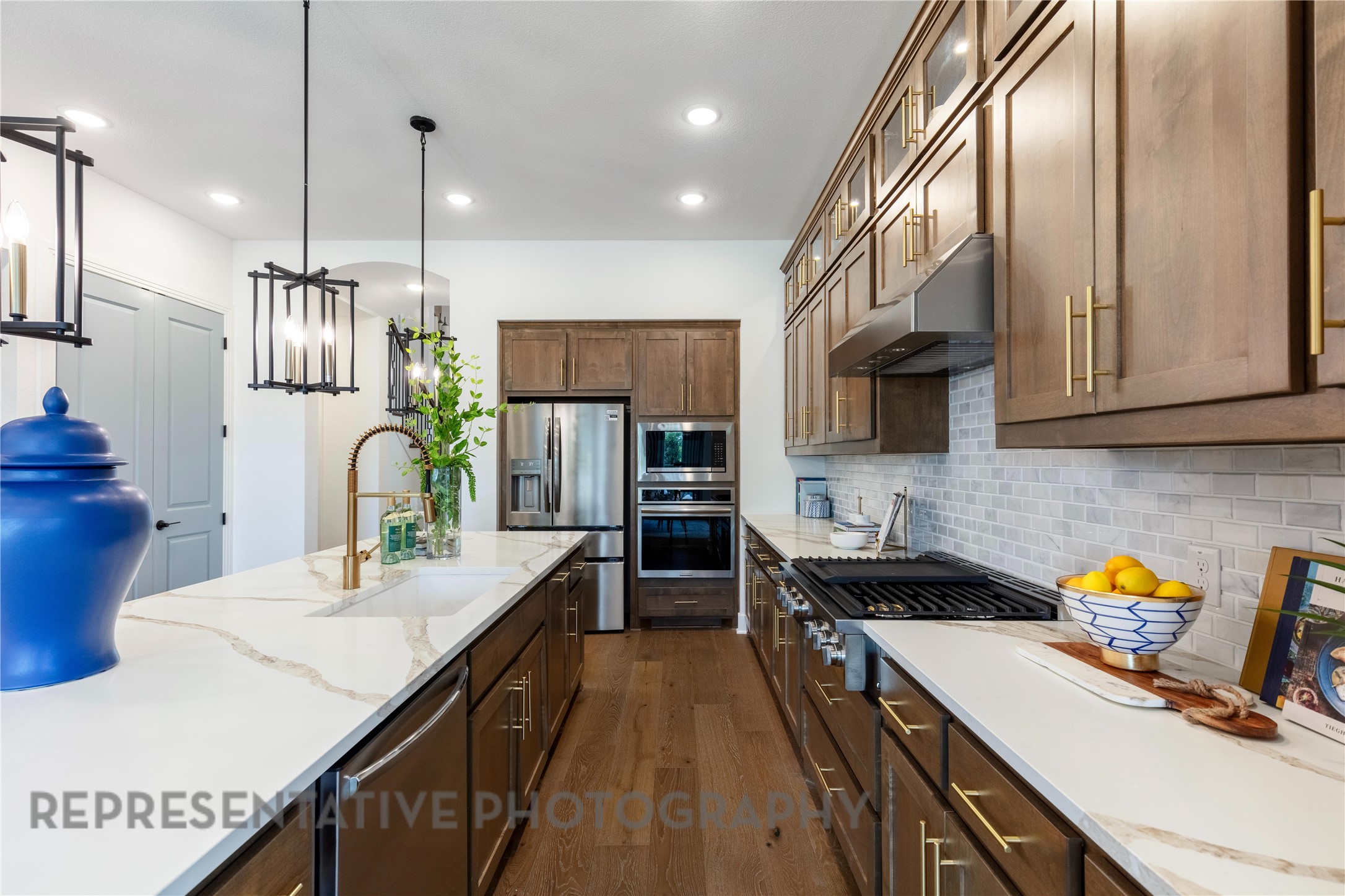 21235 Natalia Grove Magnolia, TX 77355 - Photo 7 of 34 a kitchen with stainless steel appliances kitchen island granite countertop a sink a stove and cabinets