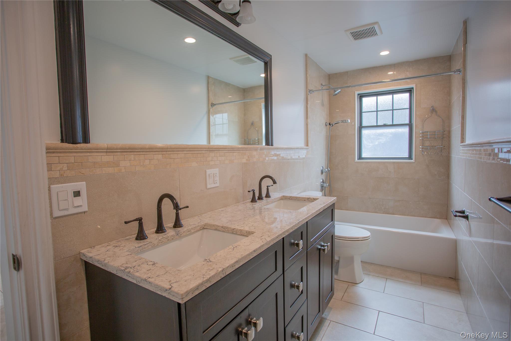 59 Clinton Avenue Inwood, NY 11096 - Photo 16 of 19 a bathroom with a sink a vanity and a bathtub