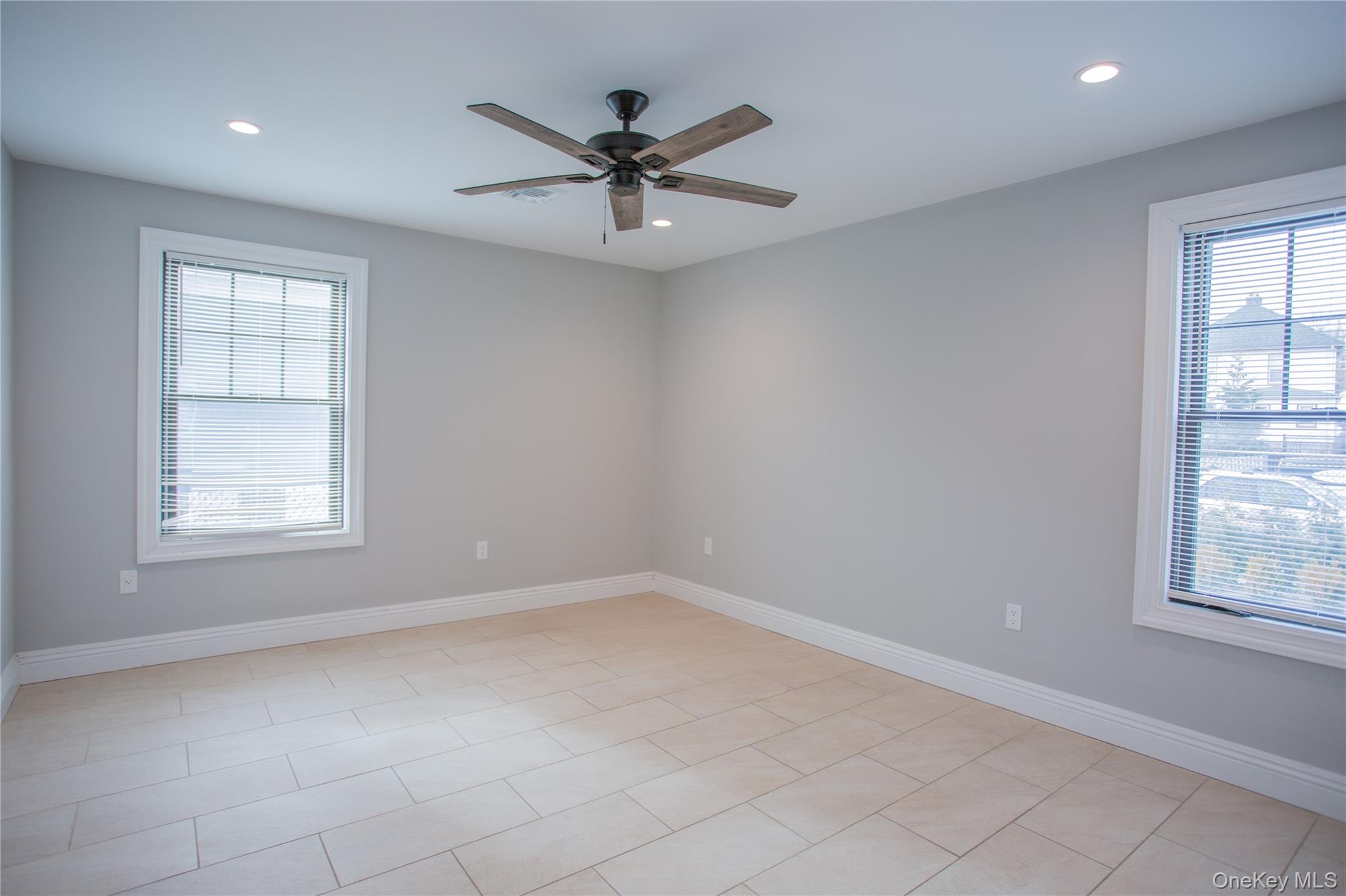 59 Clinton Avenue Inwood, NY 11096 - Photo 18 of 19 an empty room with windows and fan