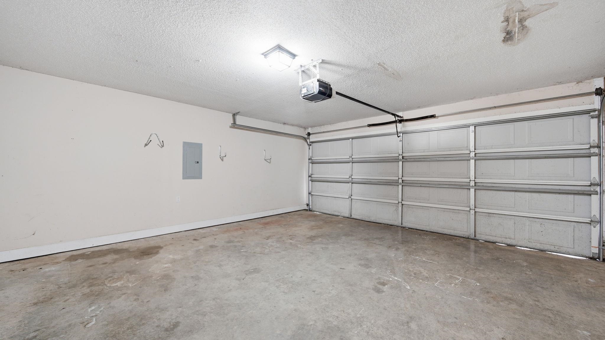 217 Rae Drive Munford, TN 38058 - Photo 40 of 40 Spacious garage featuring a concrete floor, an automatic garage door opener, and a panel-style garage door