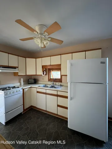 a kitchen with appliances a sink and cabinets