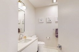 191 Washington Street, Unit 720 Boston, MA 02135 - Photo 11 of 19 a bathroom with a granite countertop sink a toilet and shower