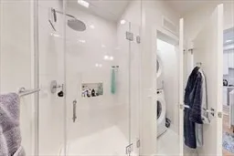 a bathroom with a shower and a glass door