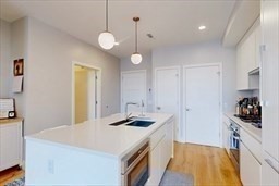191 Washington Street, Unit 720 Boston, MA 02135 - Photo 3 of 19 a kitchen with stainless steel appliances granite countertop a sink a stove and refrigerator