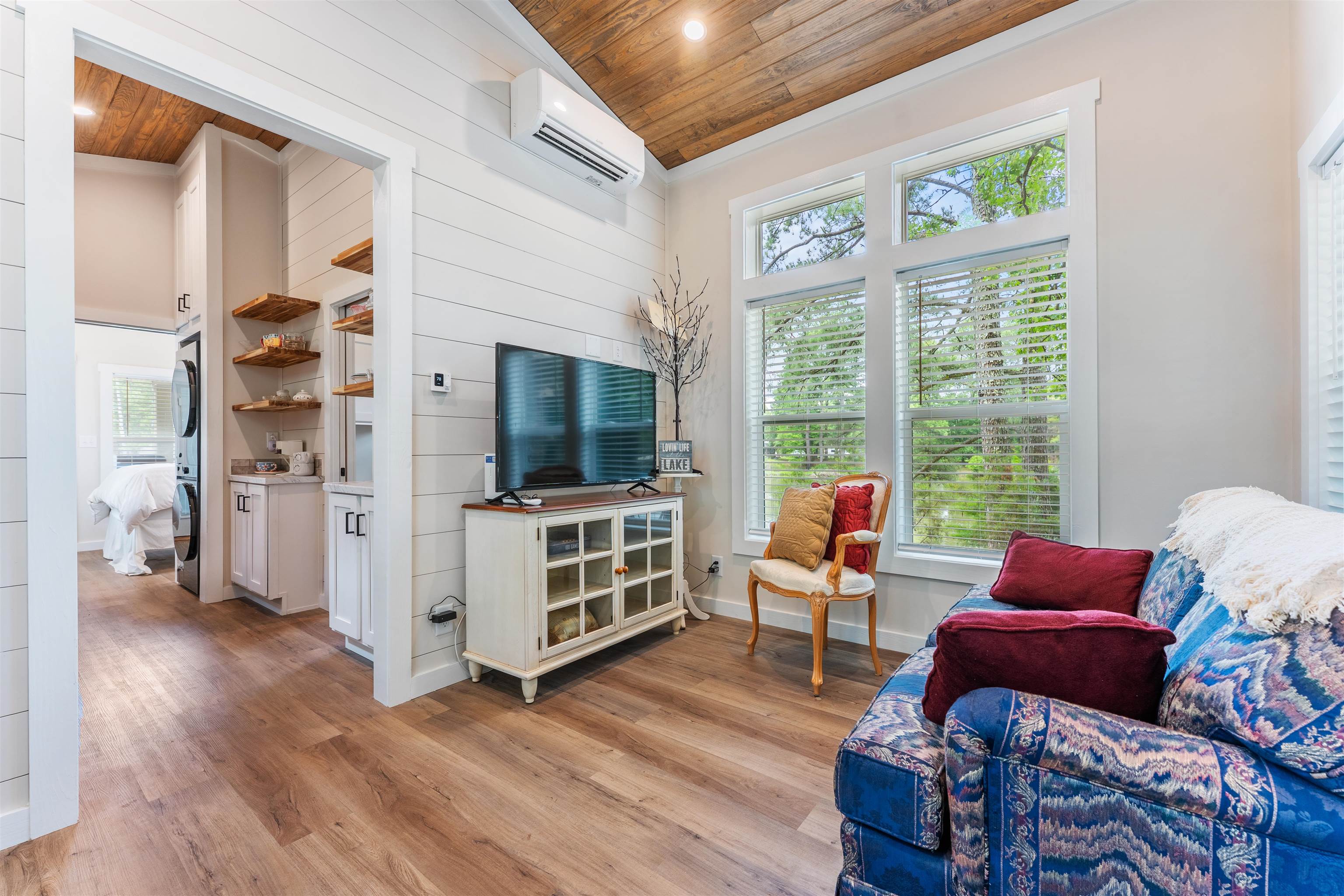 330 Whitley Road Oakland, TN 38060 - Photo 7 of 19 Living area featuring wood-finish flooring, shiplap accent wall, and a sloped wood-paneled ceiling