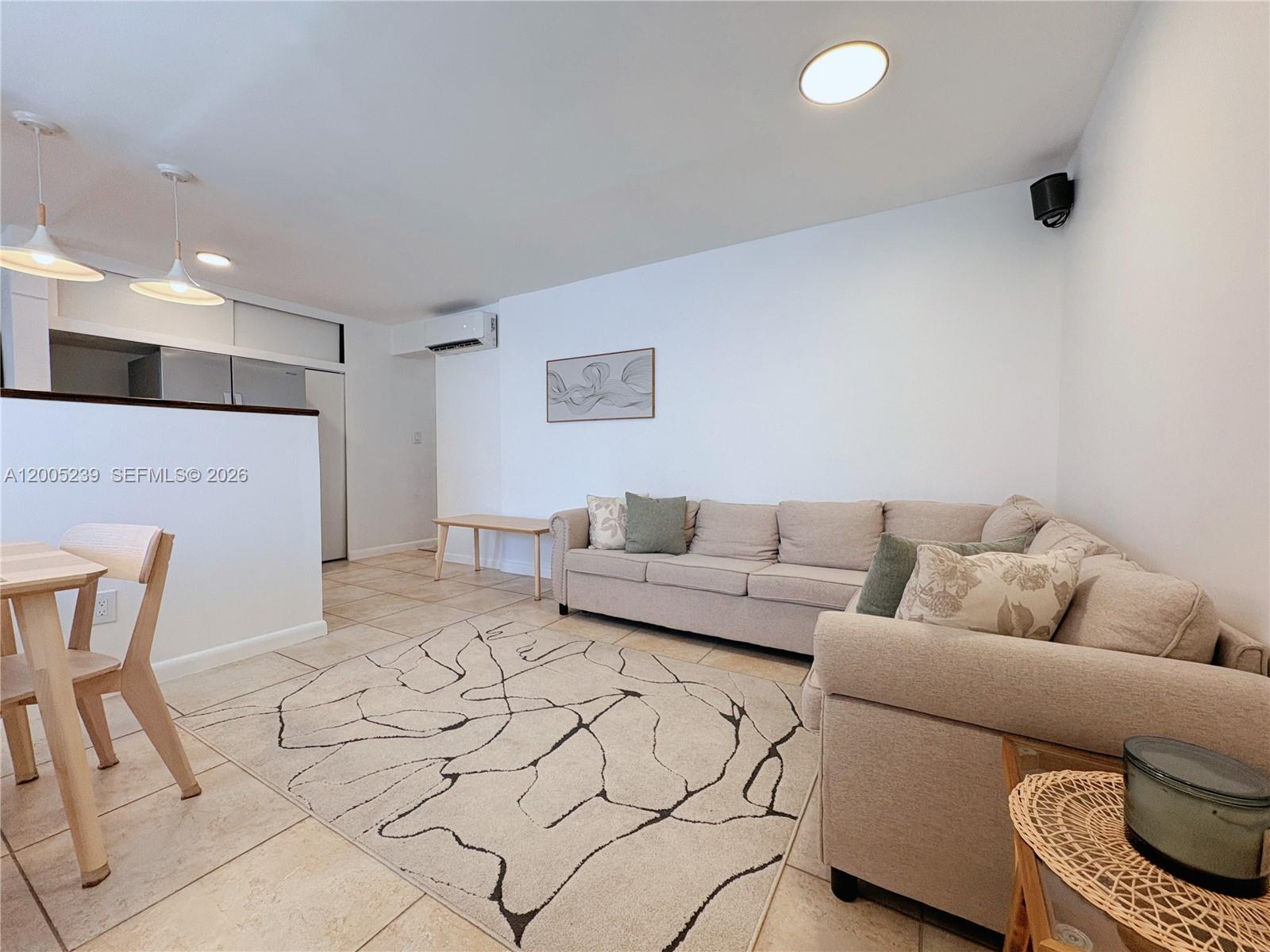 944 Meridian Avenue, Unit 11 Miami Beach, FL 33139 - Photo 1 of 14 a living room with furniture and a couch