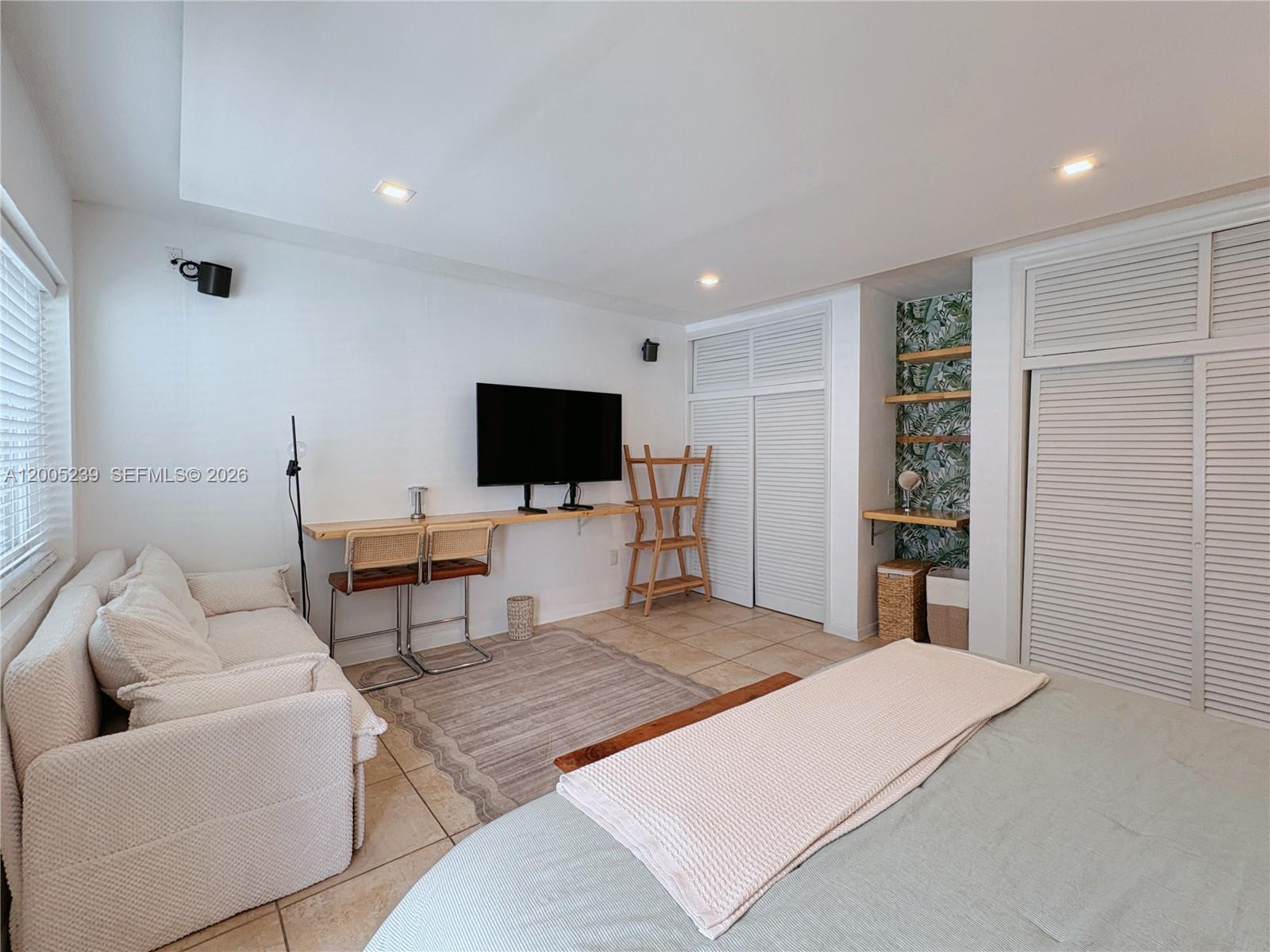 944 Meridian Avenue, Unit 11 Miami Beach, FL 33139 - Photo 12 of 14 a living room with furniture and a flat screen tv