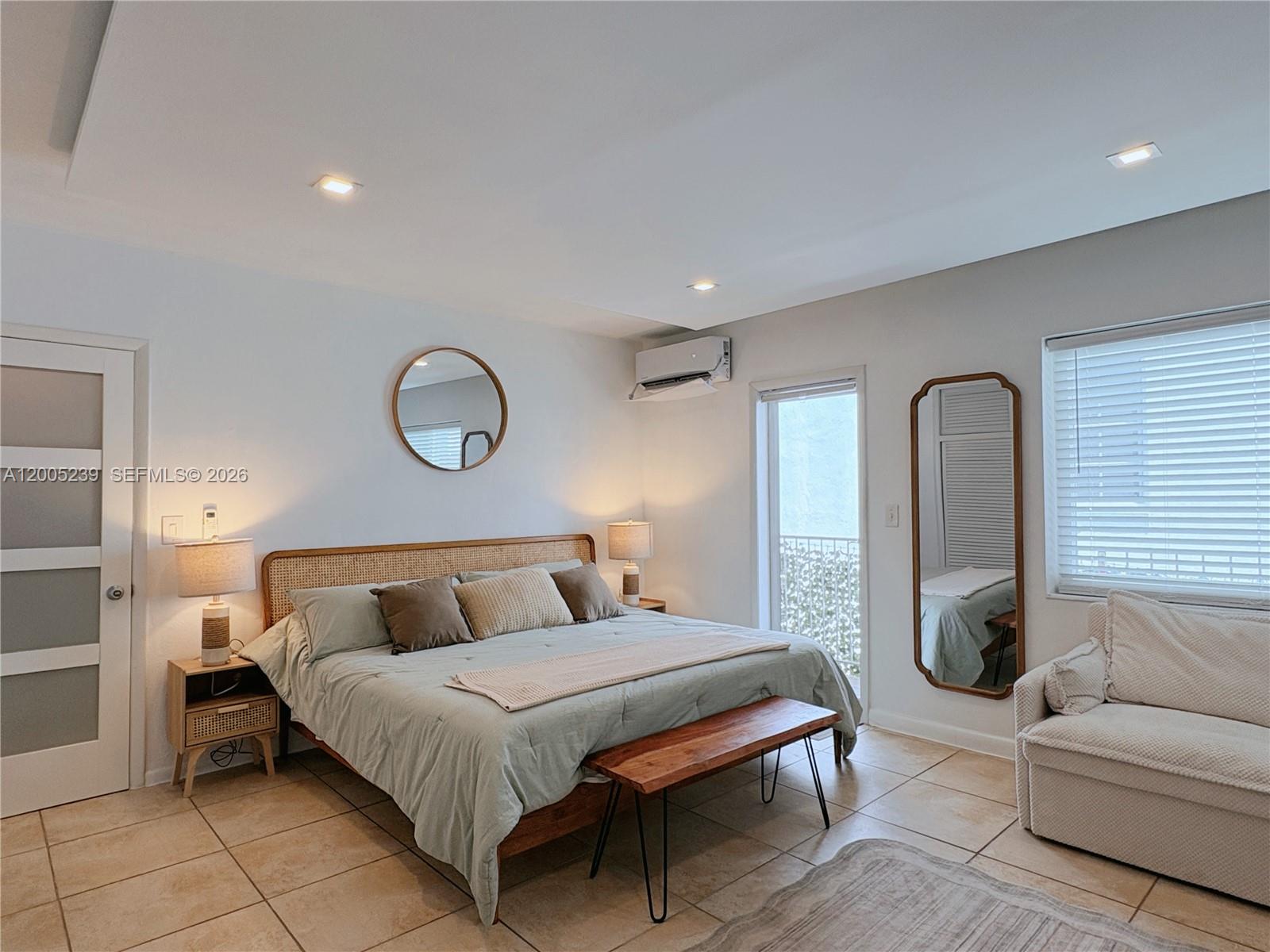 944 Meridian Avenue, Unit 11 Miami Beach, FL 33139 - Photo 13 of 14 a bedroom with bed and a couch
