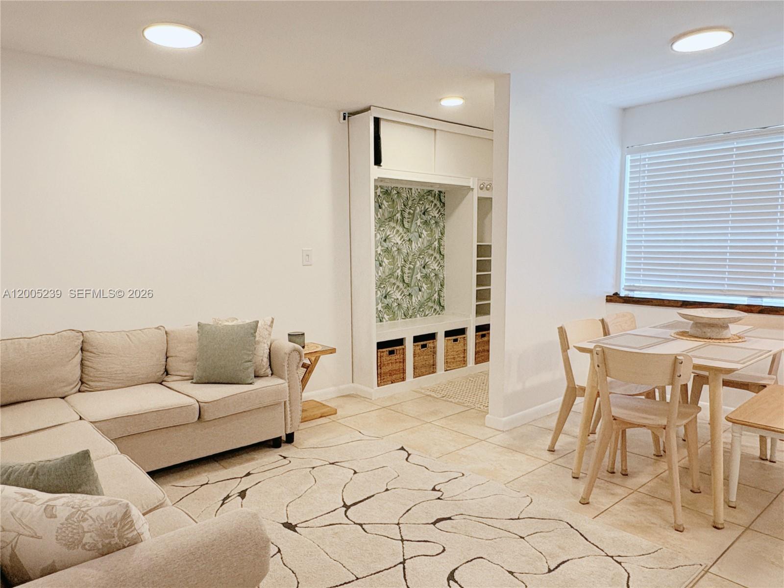 944 Meridian Avenue, Unit 11 Miami Beach, FL 33139 - Photo 4 of 14 a living room with furniture and a flat screen tv