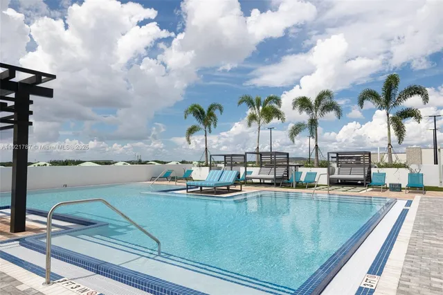 a view of a swimming pool with outdoor seating