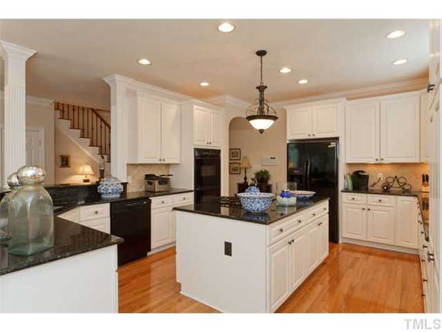 1909 Torrington Street Raleigh, NC 27615 - Photo 8 of 25 a kitchen with a sink stove cabinets and refrigerator