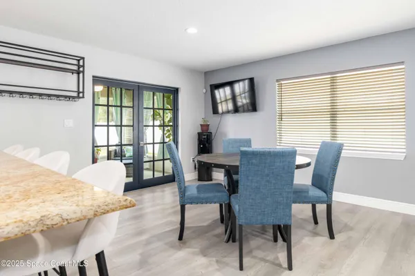 a view of a dining room with furniture and a window