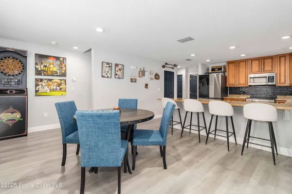a view of a dining room with furniture and wooden floor