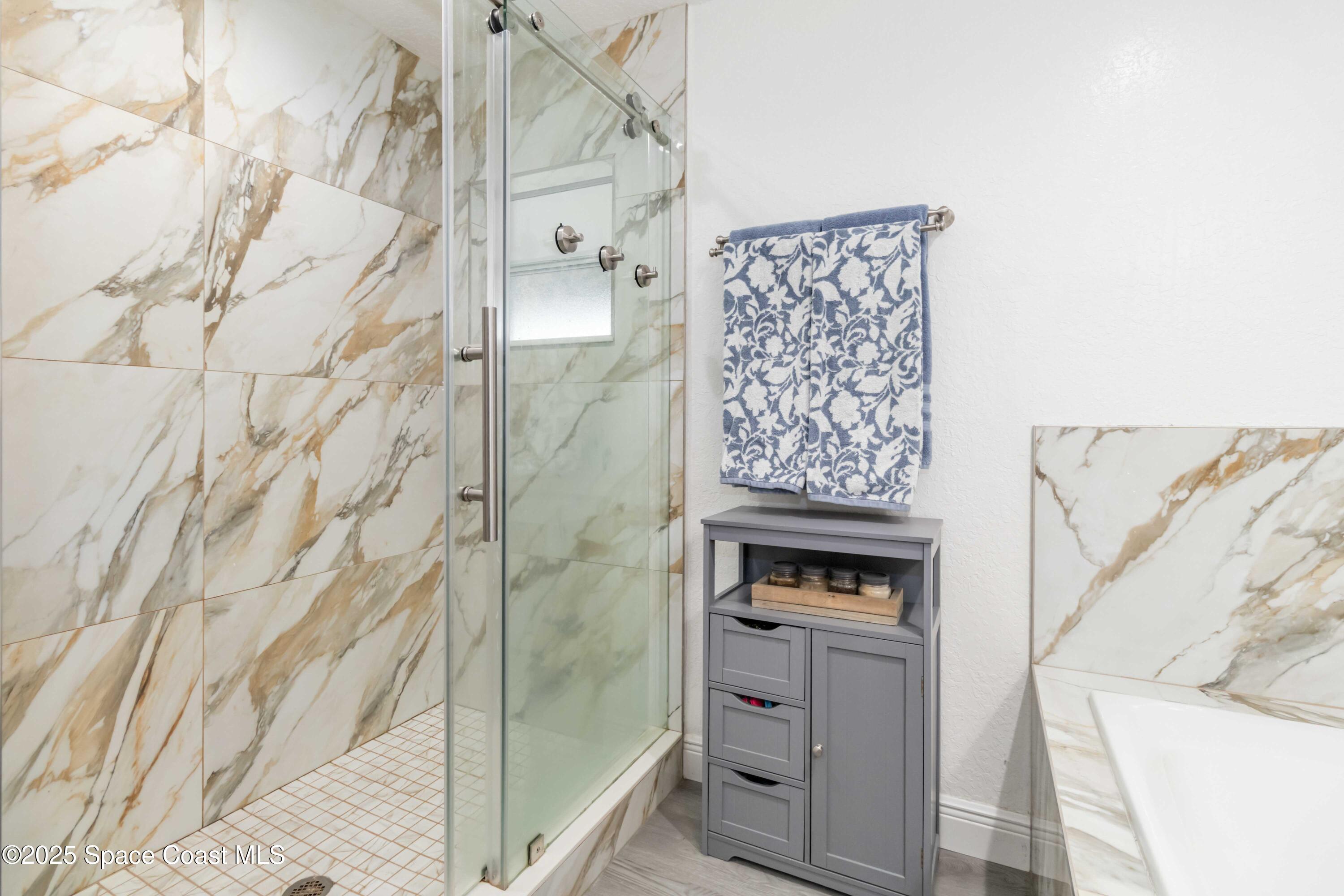 1149 Scyphers Street Northeast Palm Bay, FL 32905 - Photo 25 of 39 a view of bathroom with bathtub and shower