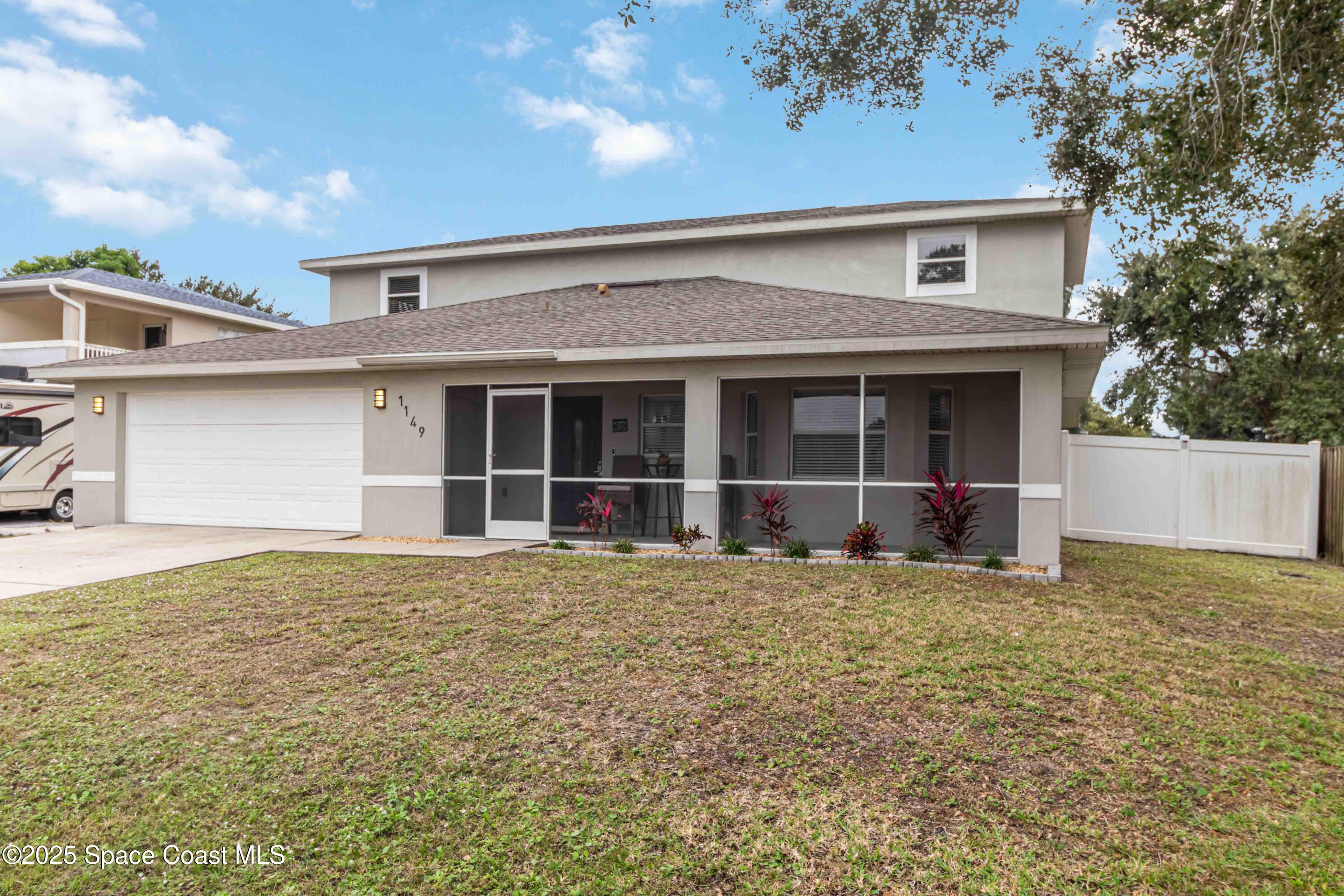 1149 Scyphers Street Northeast Palm Bay, FL 32905 - Photo 3 of 39 a view of a house with a garden
