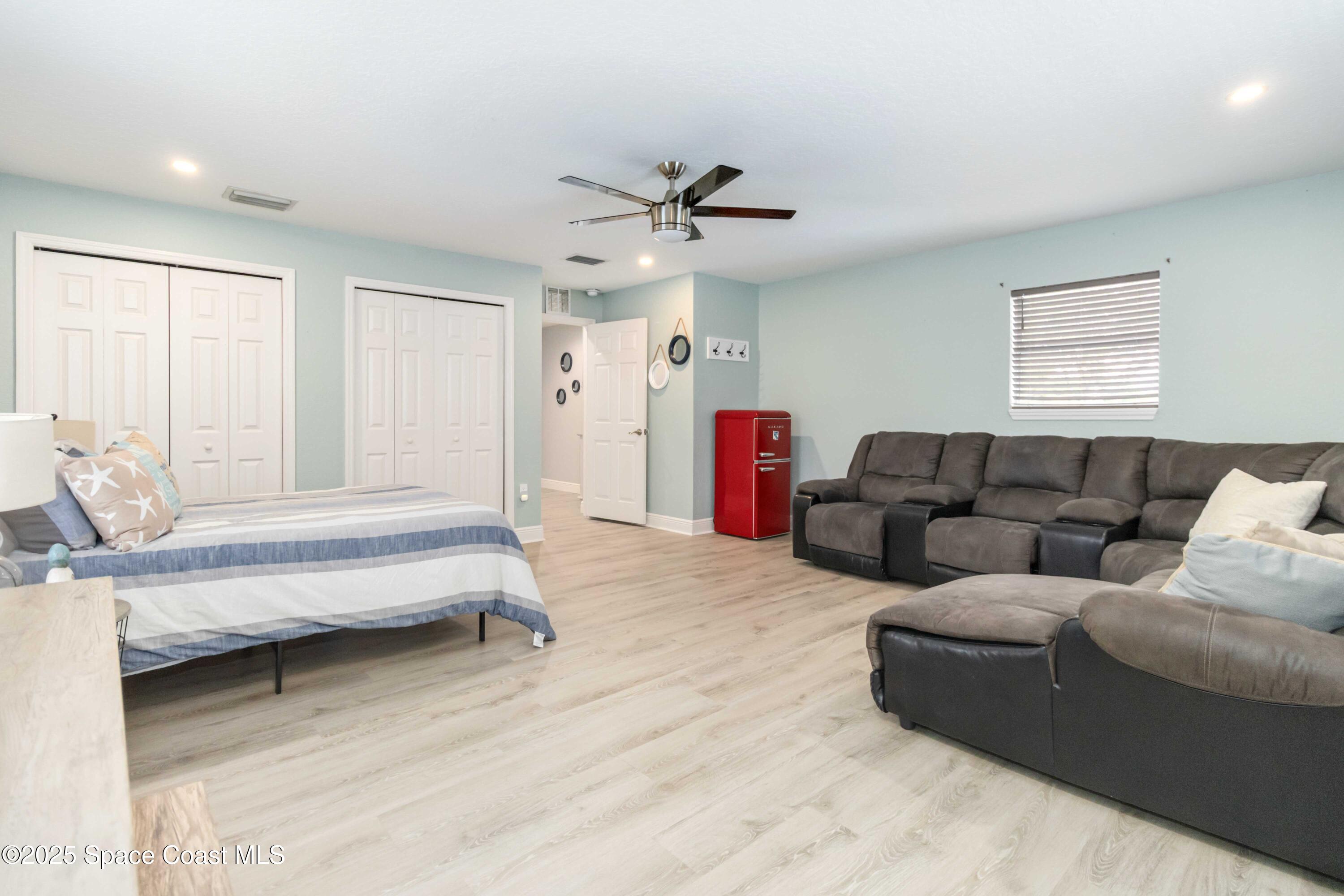 1149 Scyphers Street Northeast Palm Bay, FL 32905 - Photo 31 of 39 a living room with furniture and a ceiling fan
