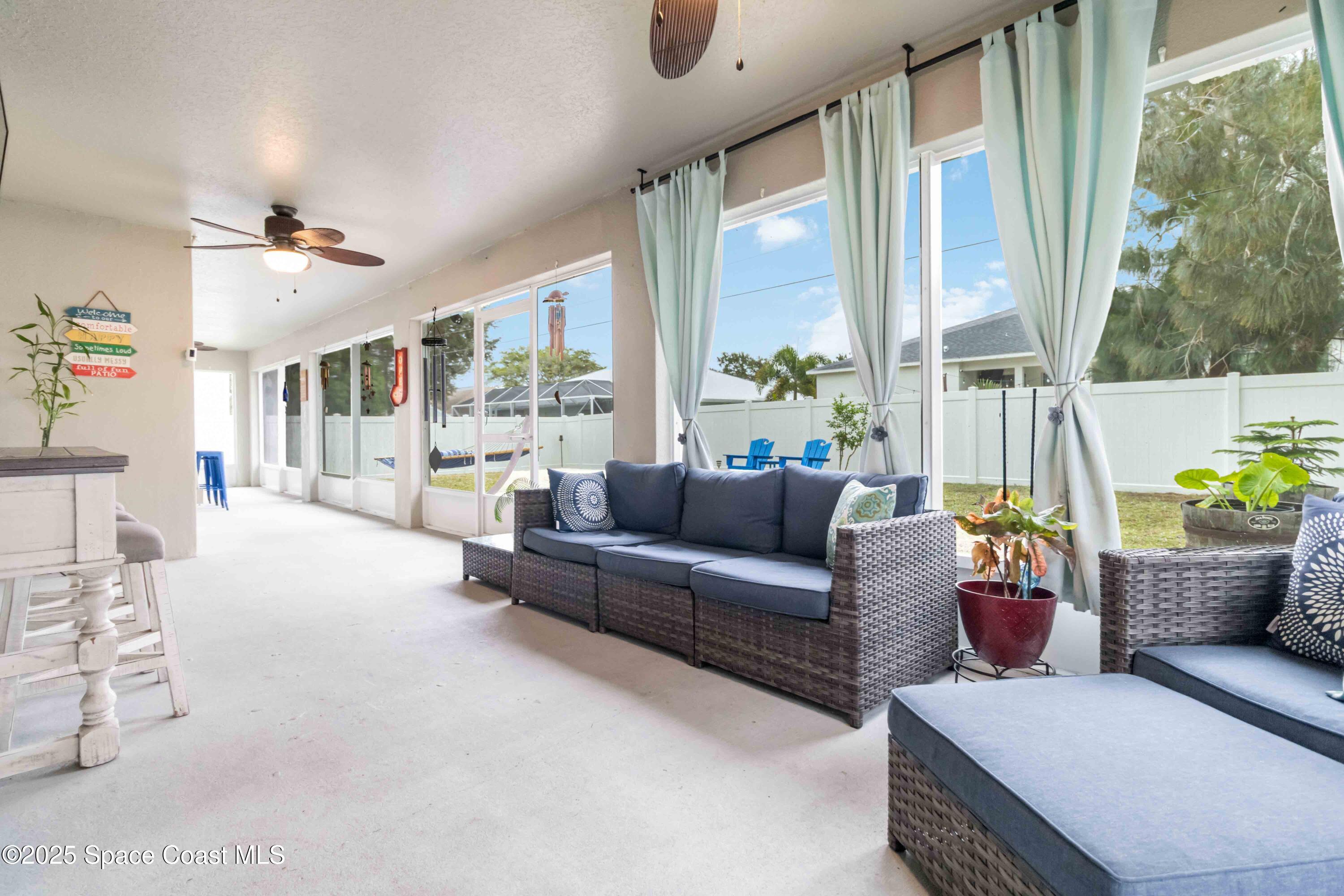 1149 Scyphers Street Northeast Palm Bay, FL 32905 - Photo 32 of 39 a living room with furniture and a large window
