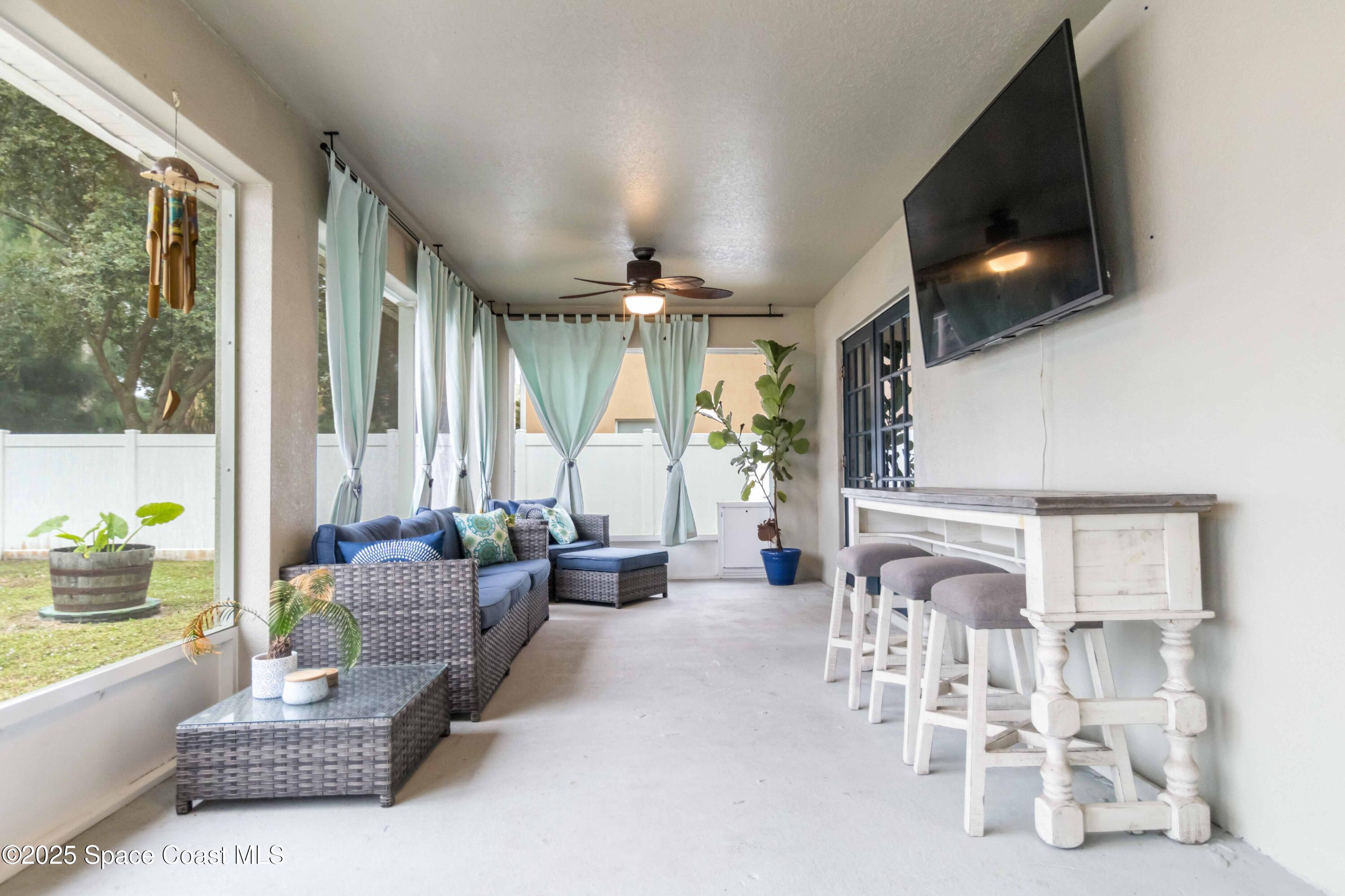 1149 Scyphers Street Northeast Palm Bay, FL 32905 - Photo 33 of 39 a living room with furniture and a flat screen tv