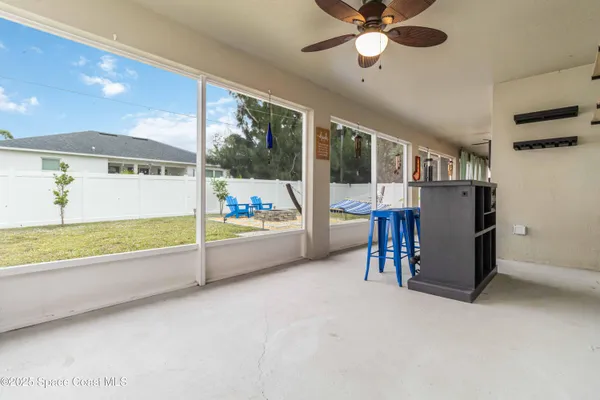 a view of kitchen with furniture and refrigerator