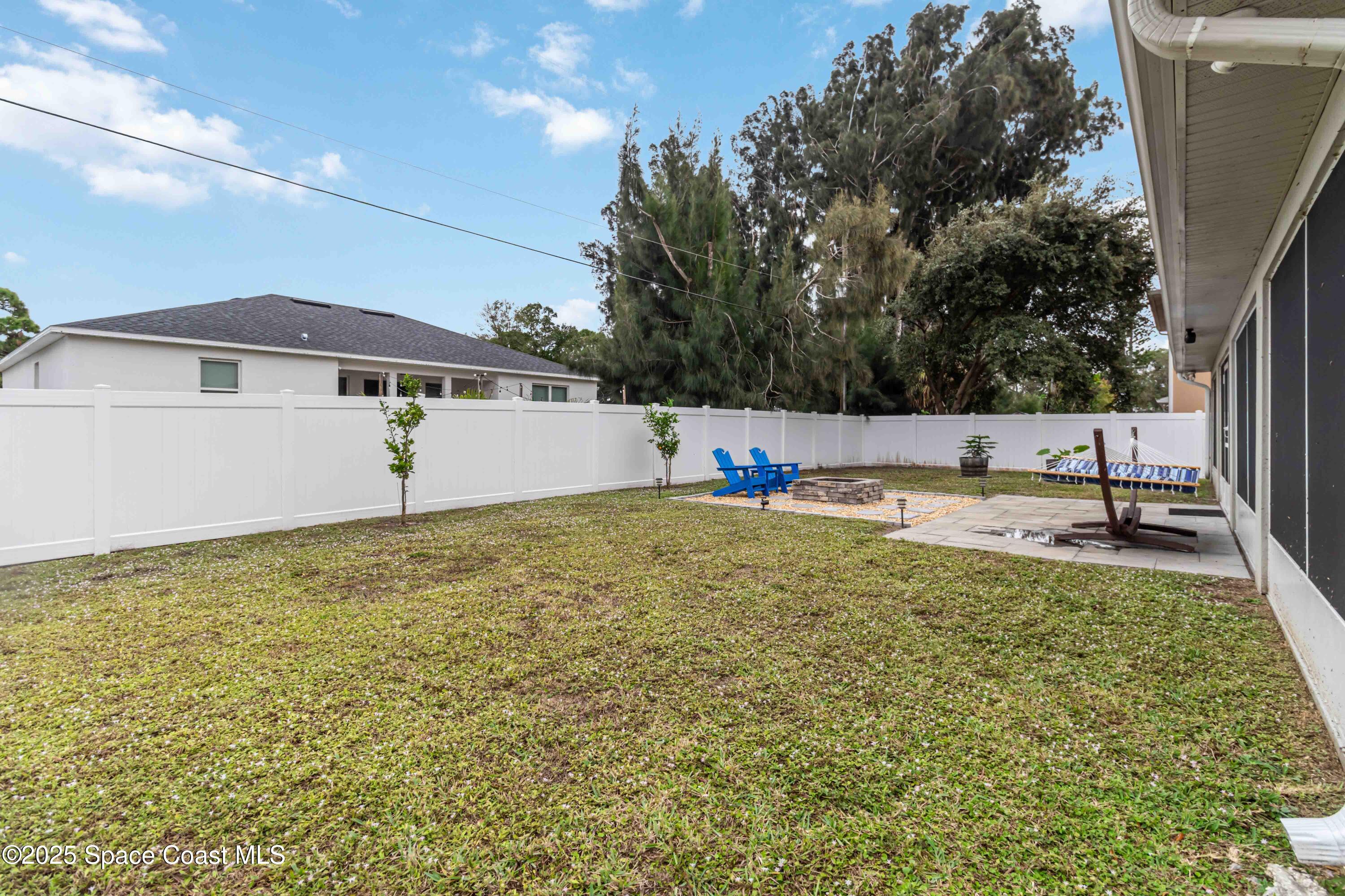 1149 Scyphers Street Northeast Palm Bay, FL 32905 - Photo 36 of 39 a view of a house with a yard and sitting area