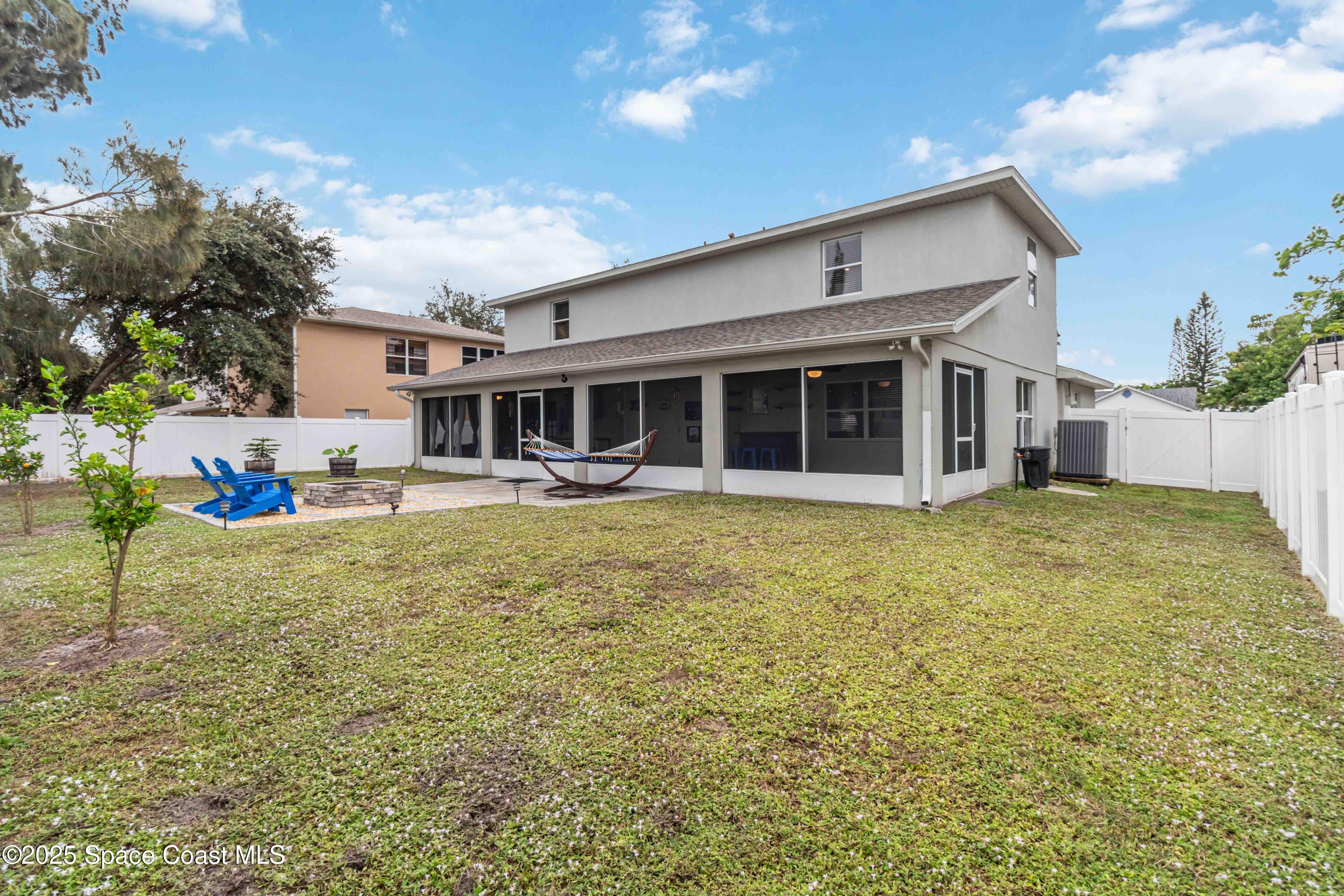 1149 Scyphers Street Northeast Palm Bay, FL 32905 - Photo 37 of 39 a front view of a house with garden