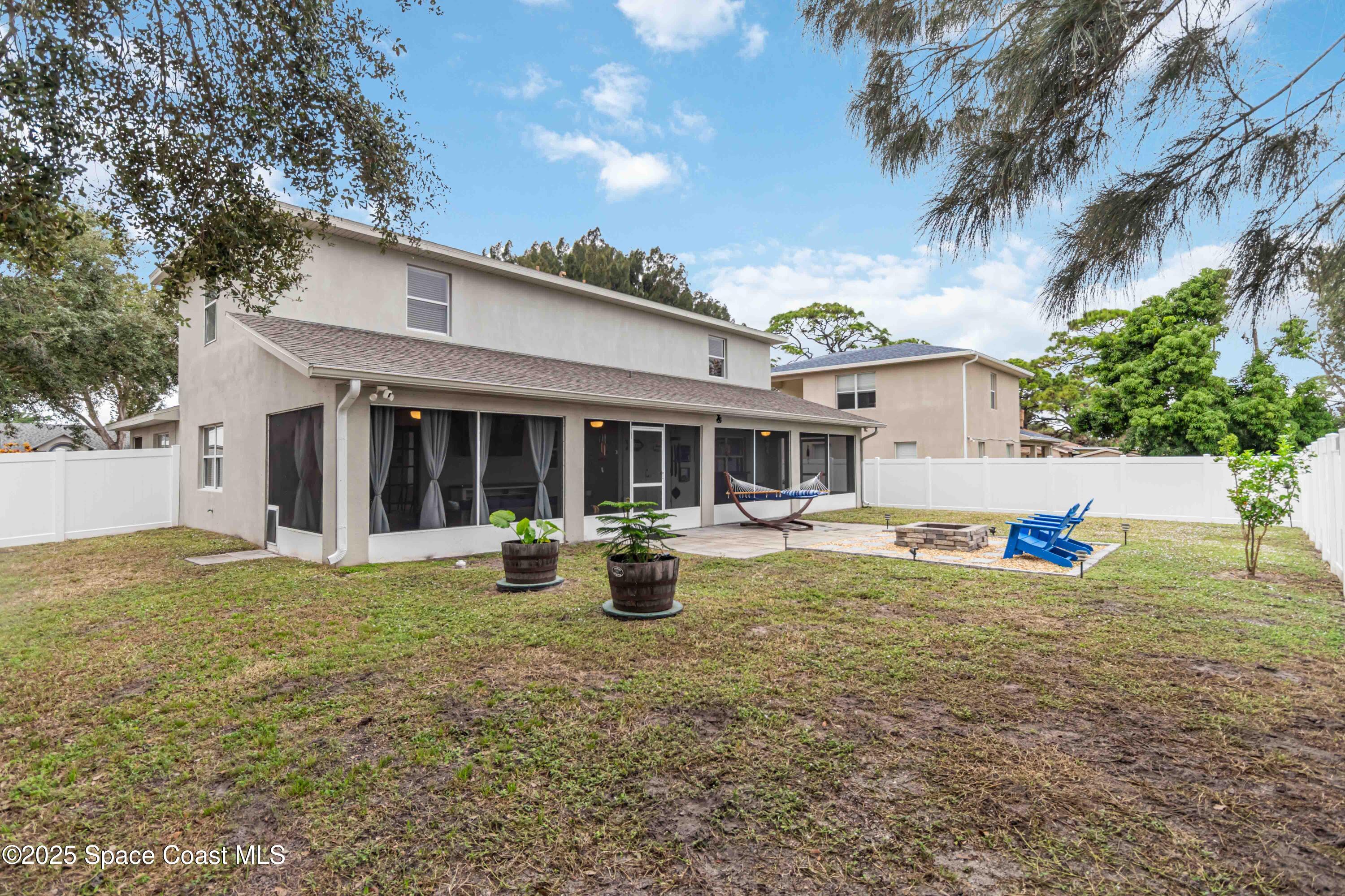 1149 Scyphers Street Northeast Palm Bay, FL 32905 - Photo 38 of 39 a view of a house with backyard and sitting area