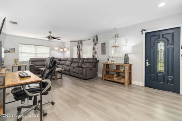 a work room with furniture and wooden floor
